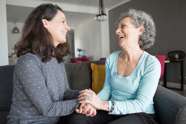Positive elderly woman and her daughter chatting, laughing Free Photo