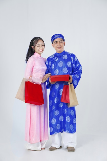 Premium Photo Positive Vietnamese Young Couple In Traditional Custom For Lunar New Year As Known As Tet Holiday