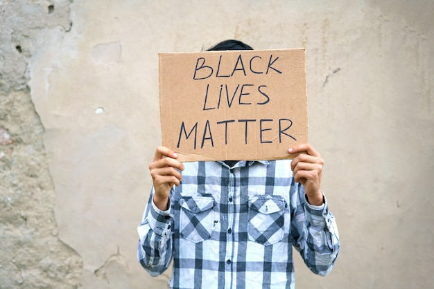 Premium Photo | Poster that says black life matters in the hands of a ...