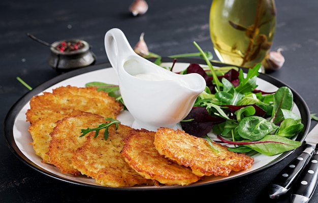 Free Photo | Potato fritters served with sour cream