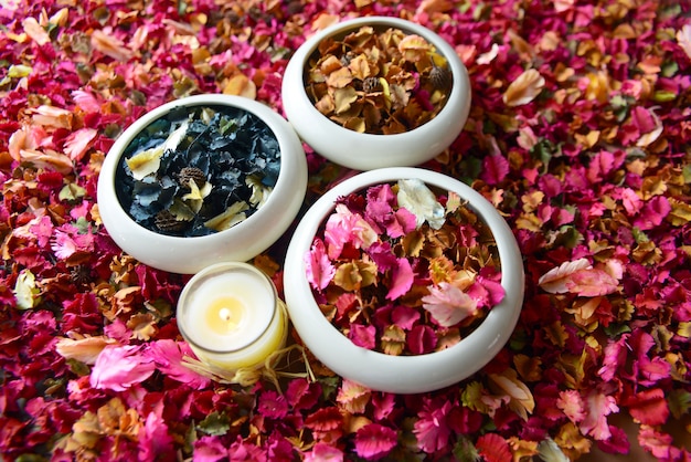 Potpourri or dried petals flowers colorful and scented candles Premium Photo