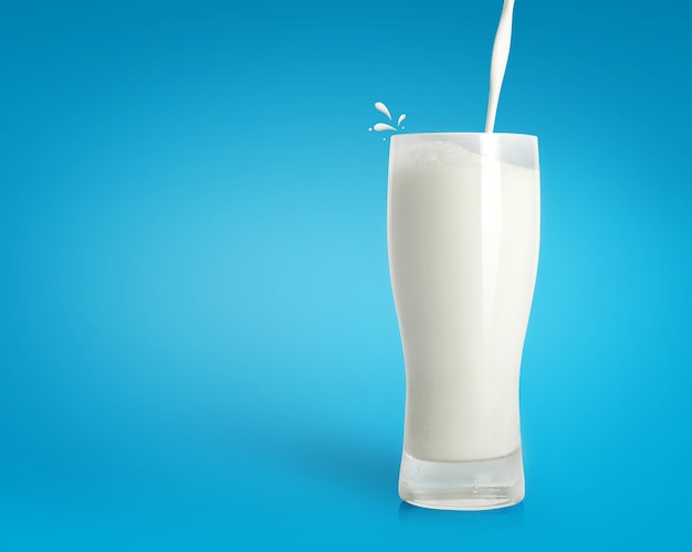 Premium Photo Pouring Fresh Milk In Glass On Blue Background