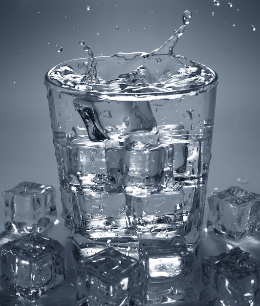 Premium Photo Pouring Ice Cube Into Drink Glass Of Water Splashing Of Water