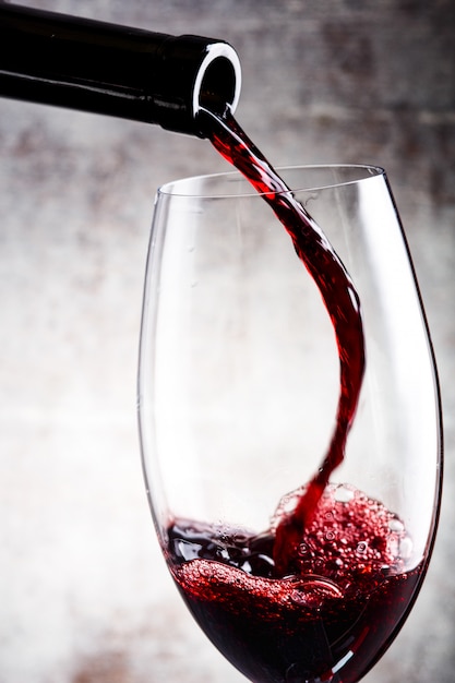 Premium Photo | Pouring red wine into the glass