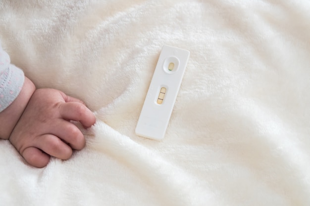 Premium Photo Pregnancy Test With Positive Pregnant And Baby Hand With Text Space