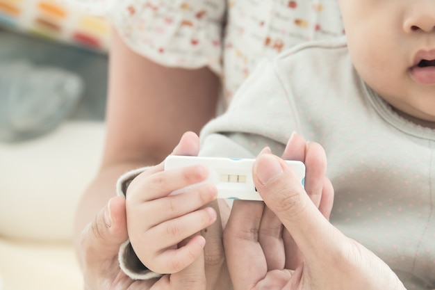 Premium Photo Pregnancy Test With Positive Pregnant In Women Hand And Baby Hand Concept Of Family