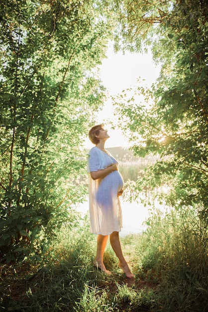 Premium Photo | Pregnant woman in outdoor park warm weather