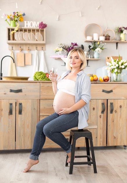 Free Photo Pregnant Woman Sitting On Chair Whil