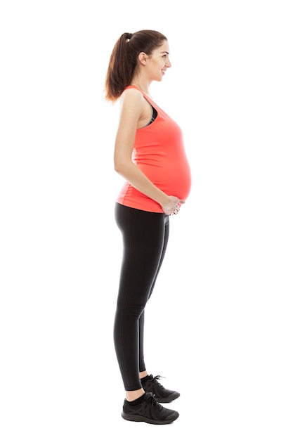 Premium Photo A Pregnant Woman In Sportswear Is Standing In Full Growth Fashioning Profile