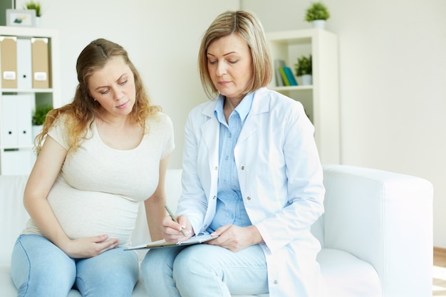 Image result for pregnant woman talking to doctor
