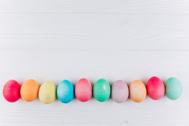 premium-photo-preparation-for-easter-olored-eggs-on-a-white-wooden