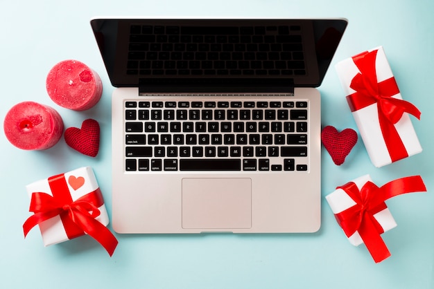 Free Photo | Presents and candles near laptop