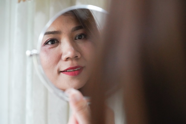 Premium Photo Pretty Asian Woman Looking Mirror For Checking Her Wrinkle