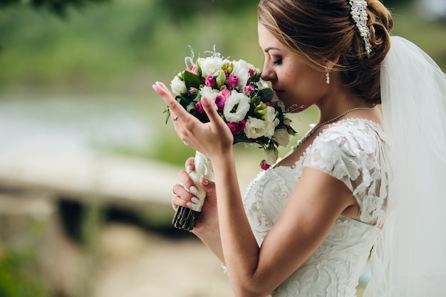 Pretty bride smelling bunch Free Photo