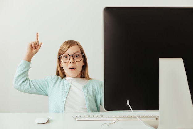 Pretty charming intelligent girl using her computer for learning new things and telling about them Premium Photo