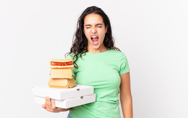 Premium Photo | Pretty hispanic woman shouting aggressively, looking ...