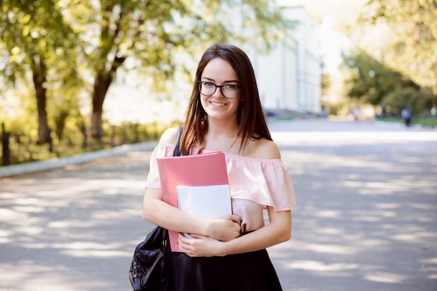 Premium Photo | Pretty smiling female student wearing spectacles and ...