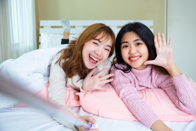 Pretty Teenage Friends Selfie On The Bed At Home Photo