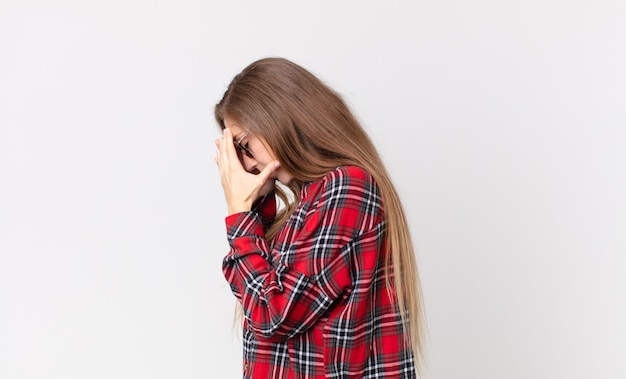 Premium Photo | Pretty thin woman covering eyes with hands with a sad ...