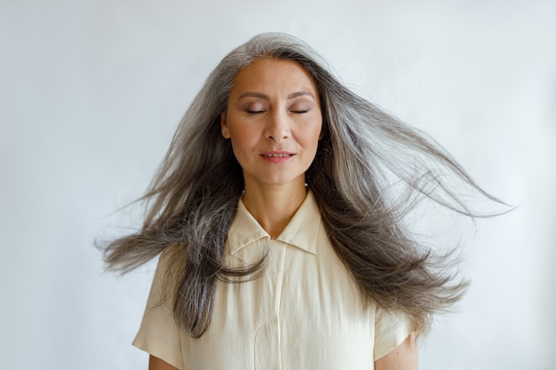 Premium Photo | Pretty tranquil asian woman with flying silver hair ...