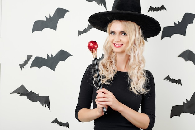 Premium Photo | Pretty witch posing with magic wand