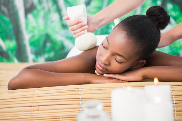 Premium Photo Pretty Woman Enjoying A Herbal Compress Massage
