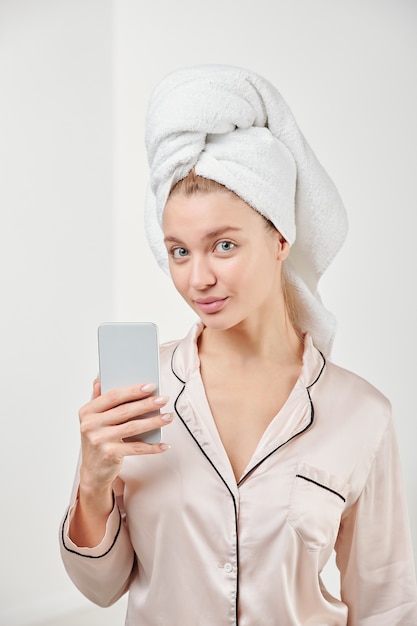 Premium Photo | Pretty young female in silk pajamas going to make ...