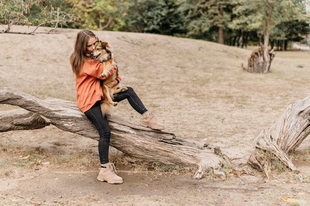 Free Photo | Pretty young woman petting her dog