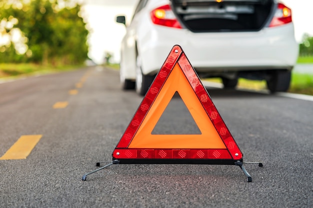 premium-photo-problems-car-and-a-red-triangle-warning-sign-on-the-road