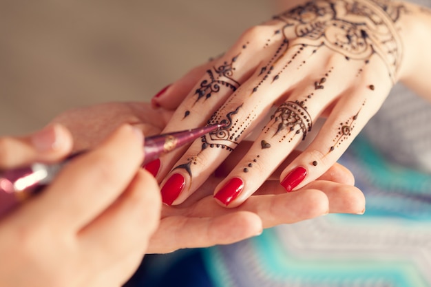 process-of-applying-mehndi-on-female-hands-premium-photo