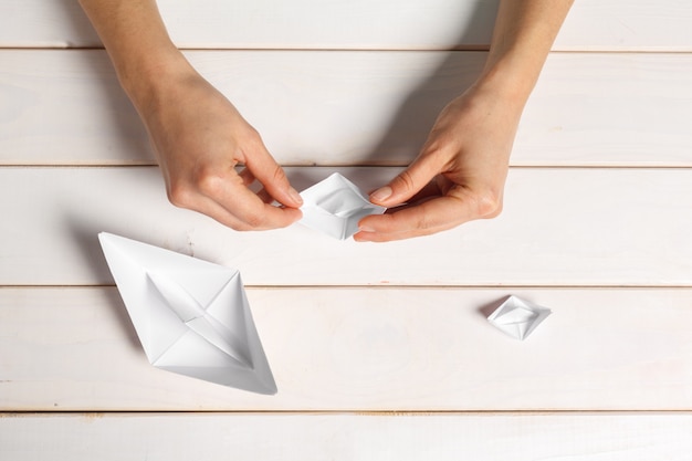 Premium Photo | Process of handcrafting origami paper boat