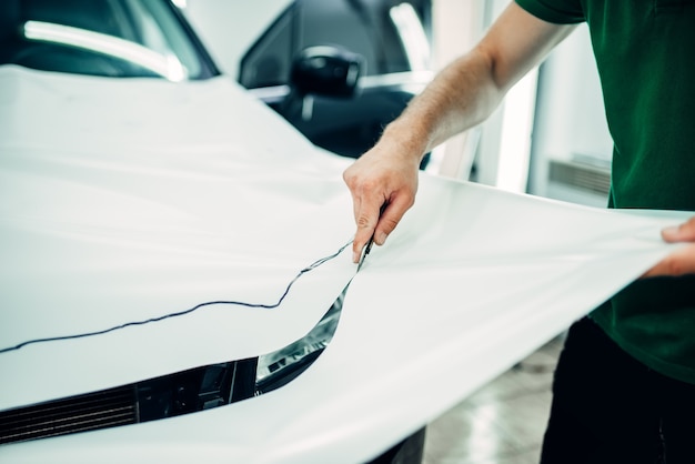 Premium Photo Professional Car Paint Protection Film Installation Process Worker Hands Prepares Protect Coating Against Chips And Scratches