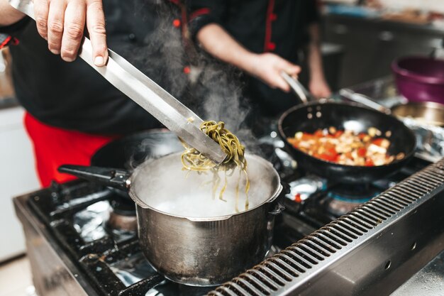 Premium Photo | Professional chef in kitchen restaurant cooking ...