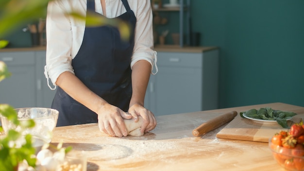 Premium Photo Professional Chef Kneads Dough For Baking On A Wooden Kitchen Table 8907