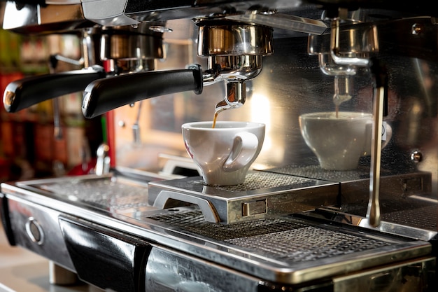 Professional coffee machine pouring espresso Photo | Free Download