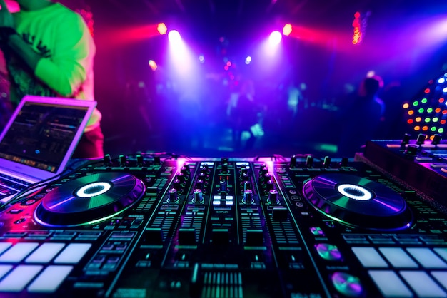 Premium Photo | Professional dj music mixer at a party at an electronic ...