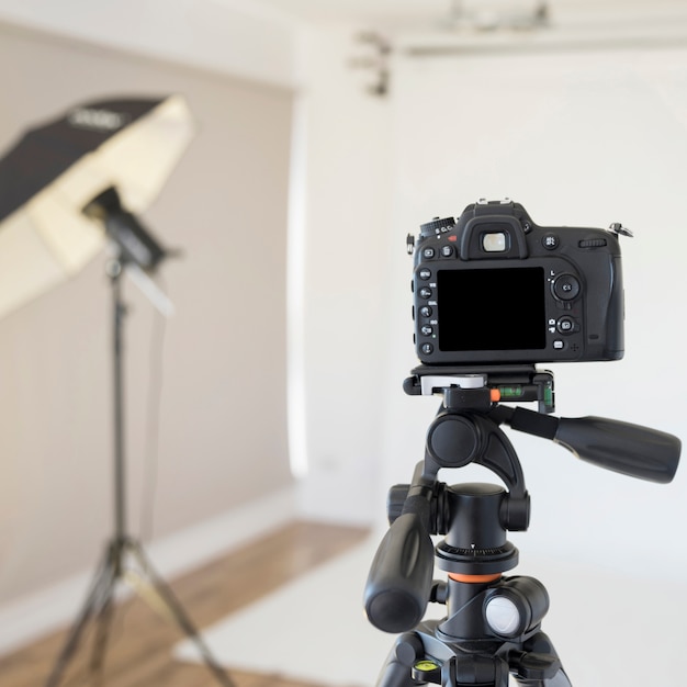 Professional dslr digital camera on tripod in photo studio