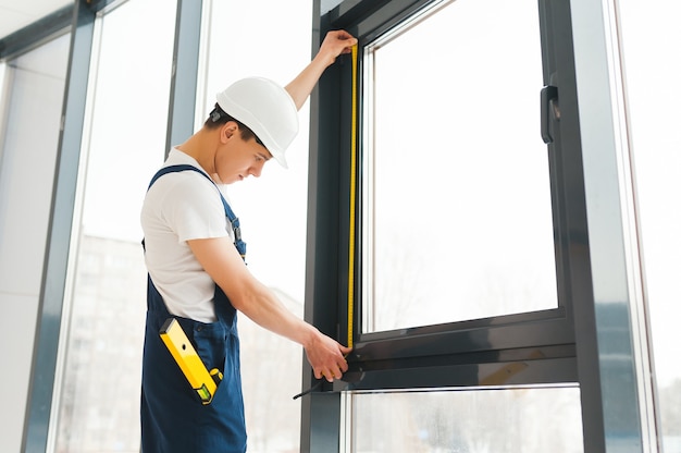 Premium Photo Professional Handyman Installing Window At Home