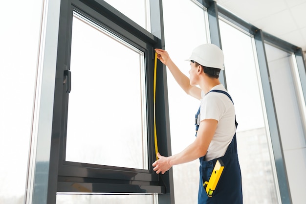 Premium Photo Professional Handyman Installing Window At Home