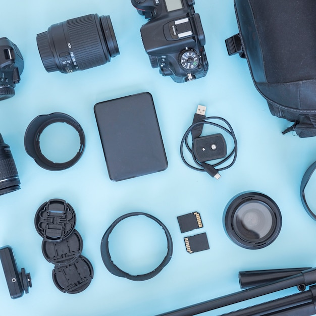 Professional photographer accessories and equipments arranged on blue ...