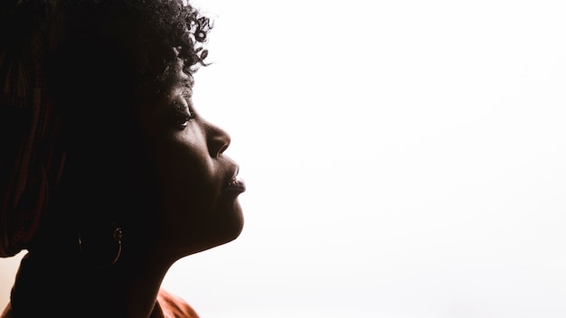 Premium Photo | Profile of african curly young woman on white background