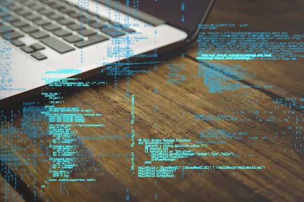 Programming code with laptop background Free Photo