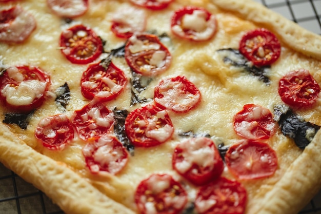 Premium Photo Puff Pastry Tart With Cherry Tomatoes Mozzarella And Purple Basil