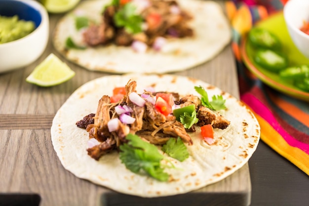 Premium Photo | Pulled pork carnitas with pico de gallo on a flour ...