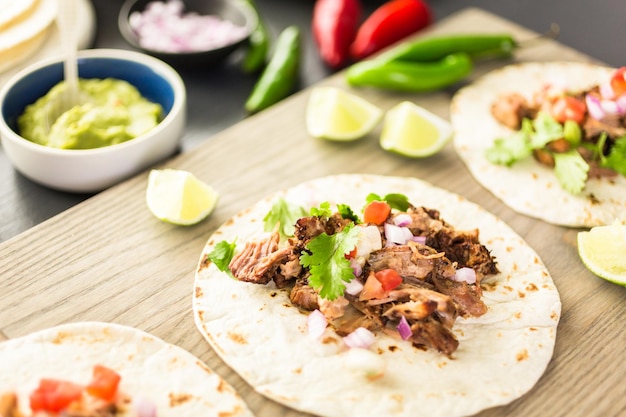 Premium Photo | Pulled pork carnitas with pico de gallo on a flour ...