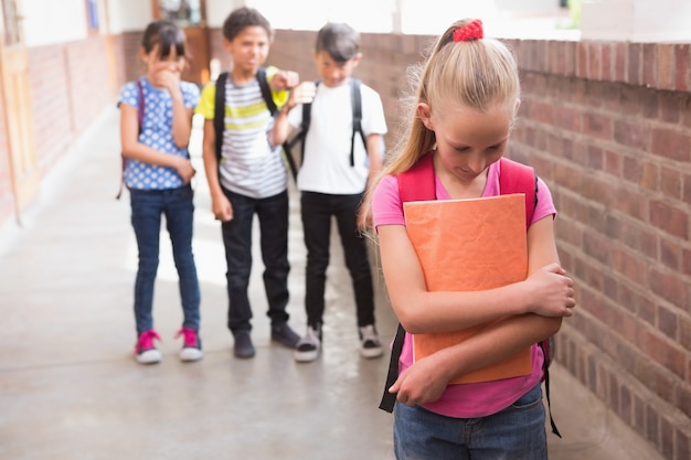 Premium Photo | Pupils friends teasing a pupil alone