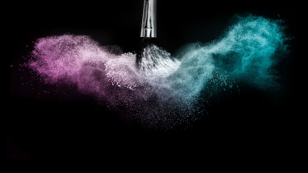 Purple and blue ocean powder color splash and brush for makeup artist Premium Photo