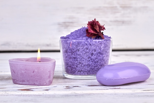 Premium Photo | Purple salt with soap and candle on white background.