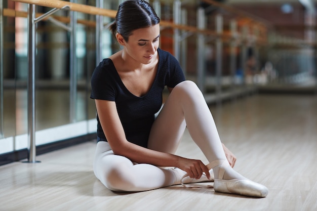 ballerina putting on shoes