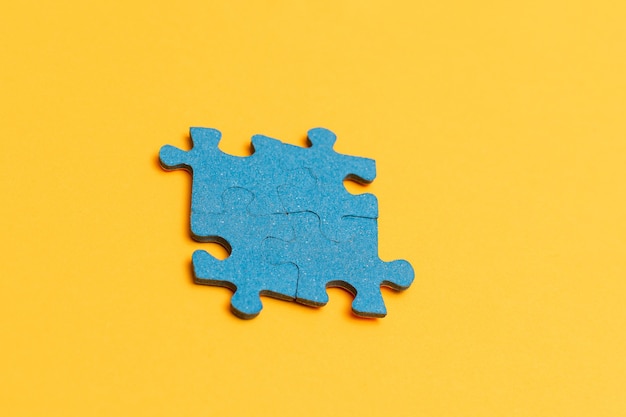 Premium Photo | Puzzle pieces on yellow background